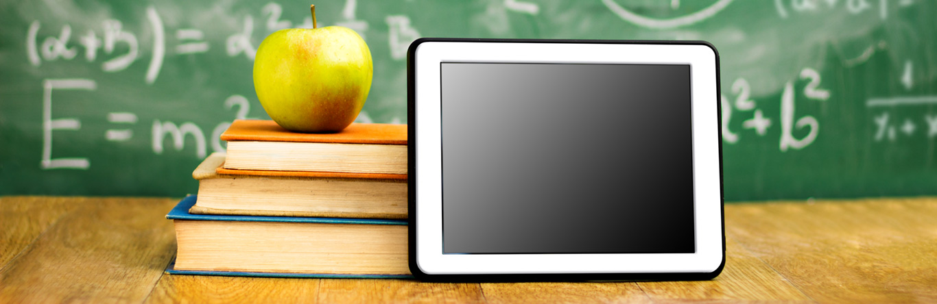 Education green apple on books next to tablet